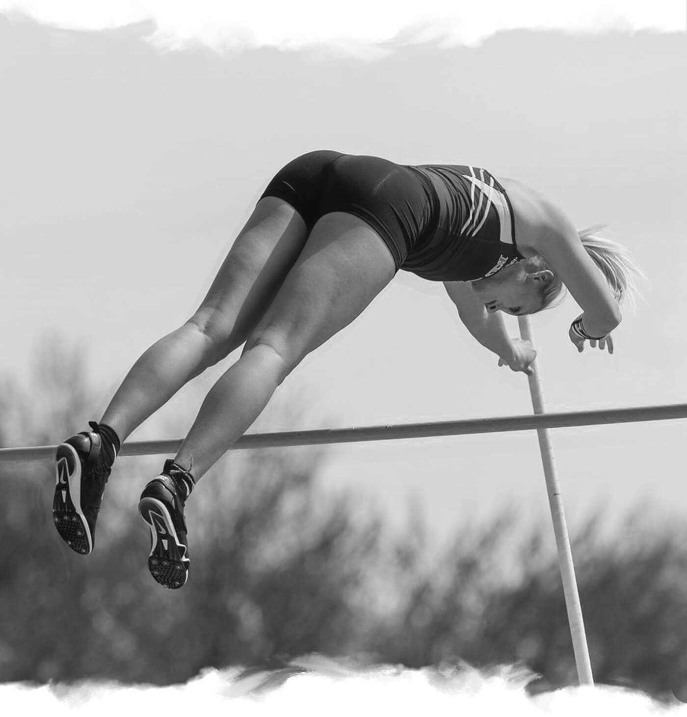 a woman is jumping in the air on a high jump