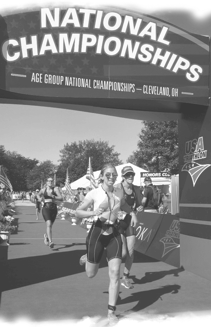 a couple of women running under a national championships sign