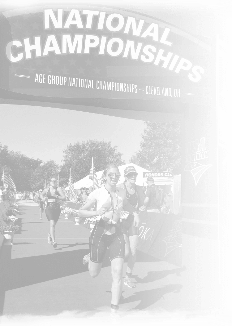 a couple of women running under a national championships sign