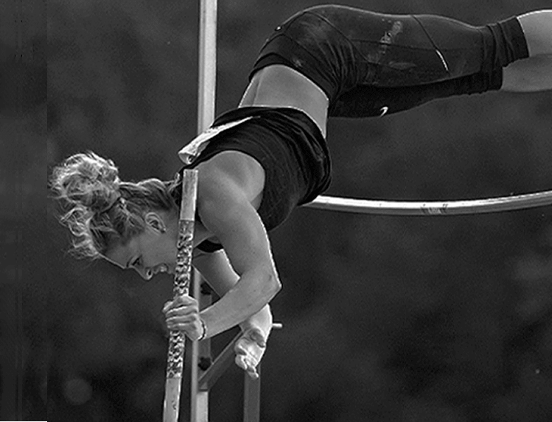 a woman is doing a high jump on a pole